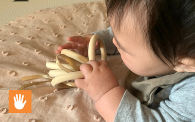 Young infant sorting color coded rings.