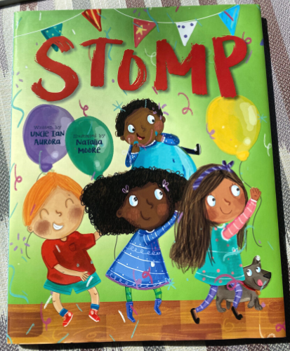 Illustration of four children smiling and stomping as they are surrounded by balloons and confetti. Text reads 'Stomp - written by Uncle Ian Aurora, illustrated by Natalia Moore'